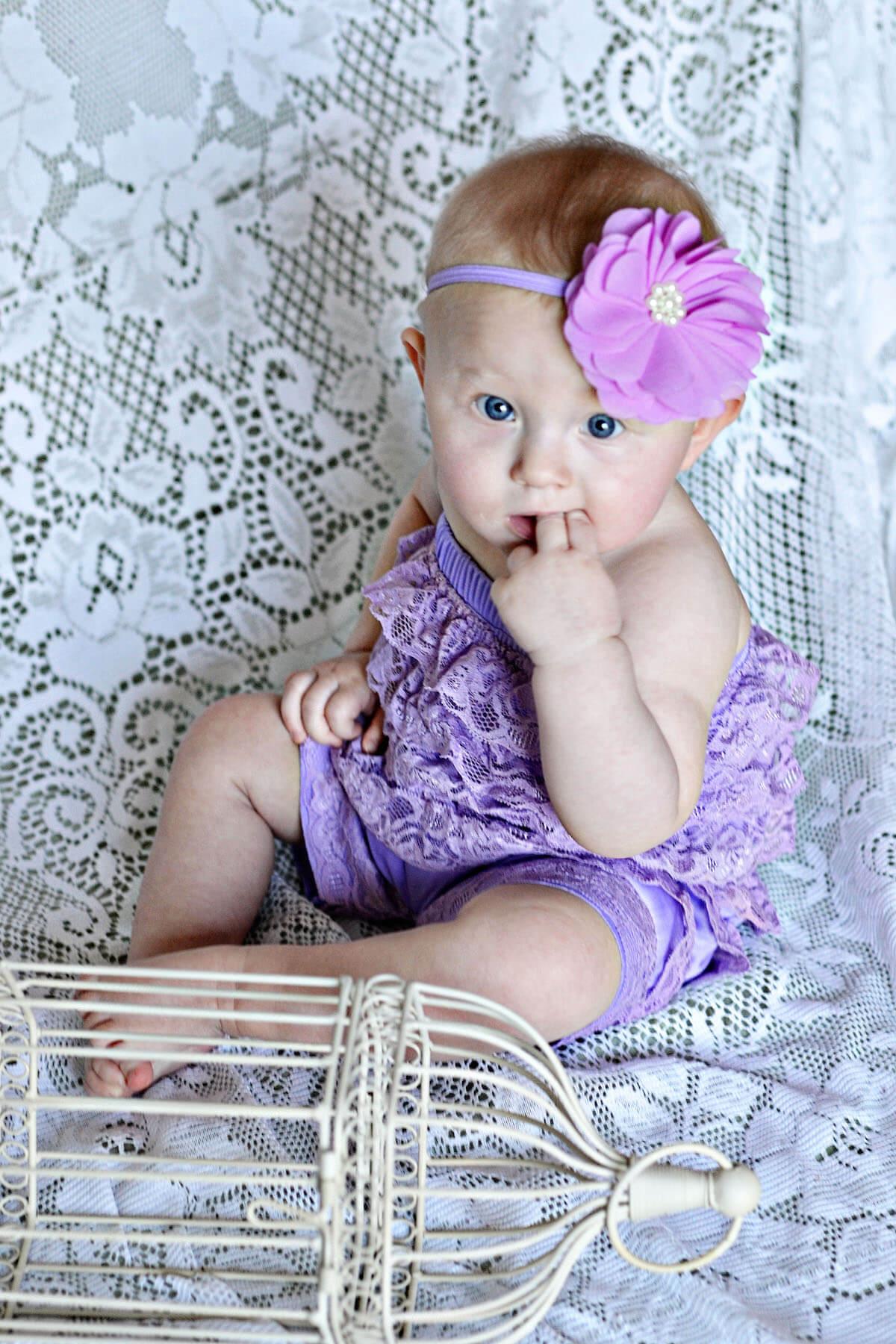 Baby girl in purple romper and matching headband