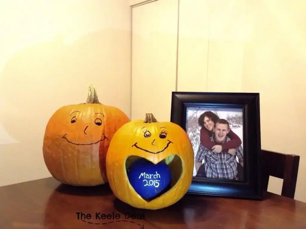 Fall pregnancy announcement with pumpkins