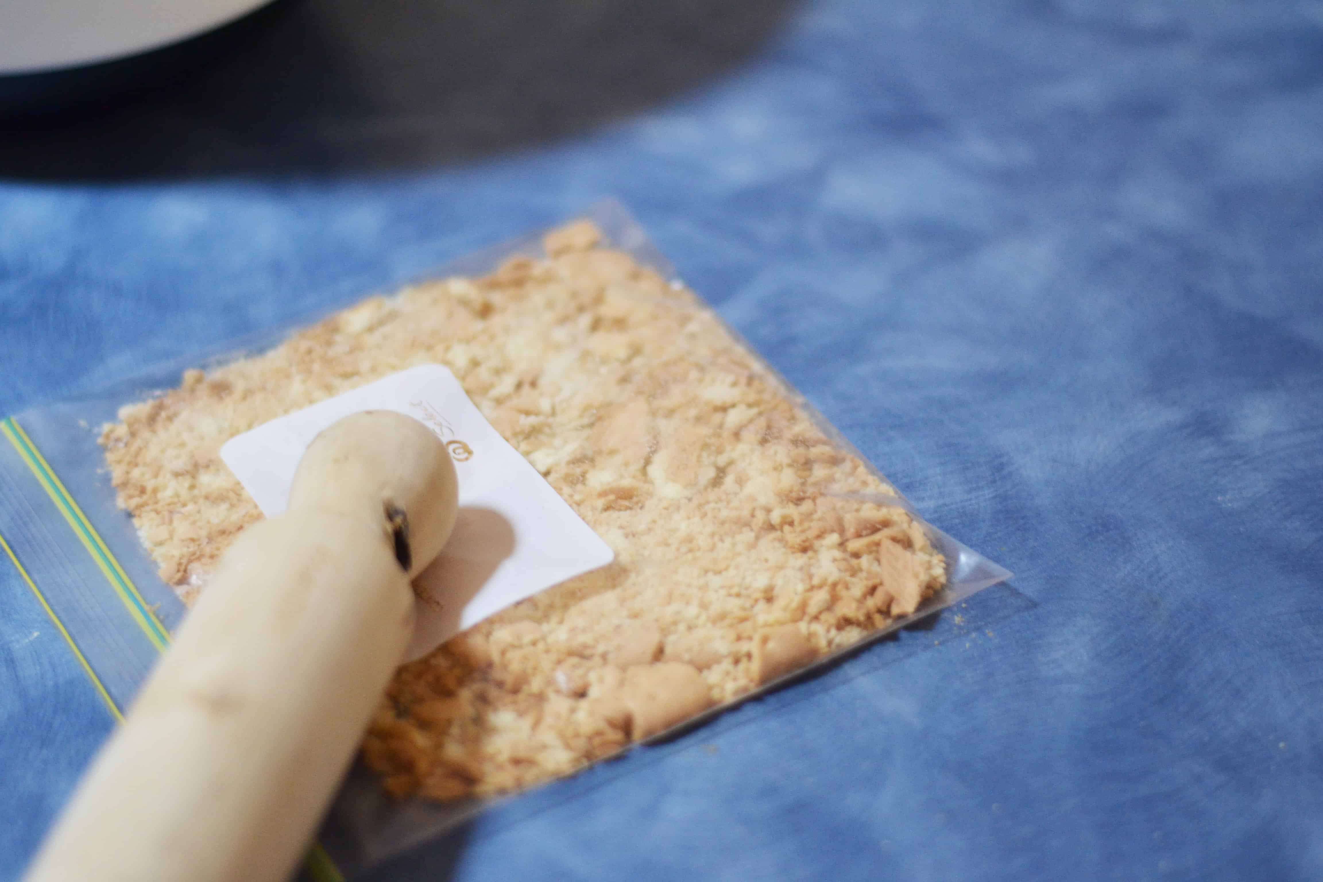 Crushing biscuits with rolling pin