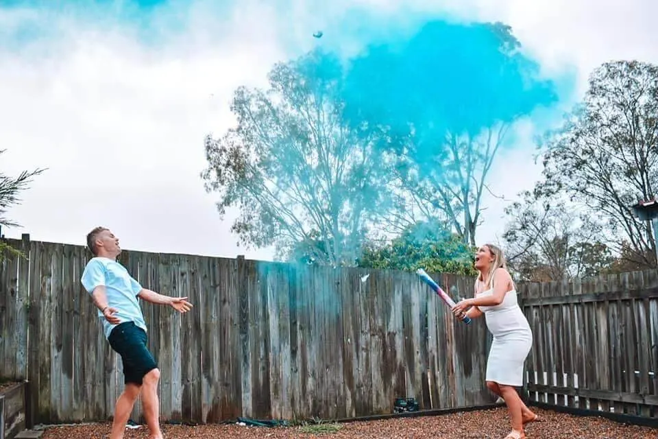 Baby gender reveal with blue powder