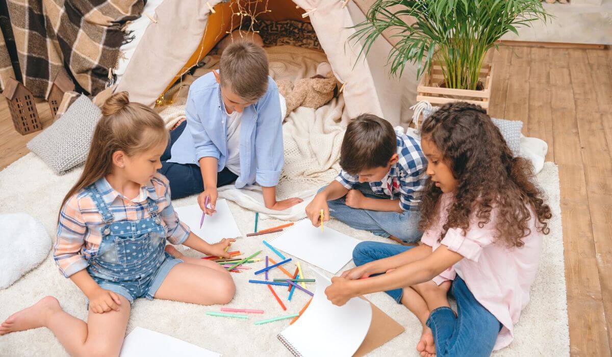 kids drawing next to a play tent