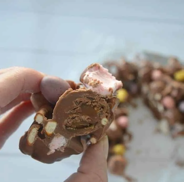 Caramel easter egg rocky road held at a close up in front of the camera
