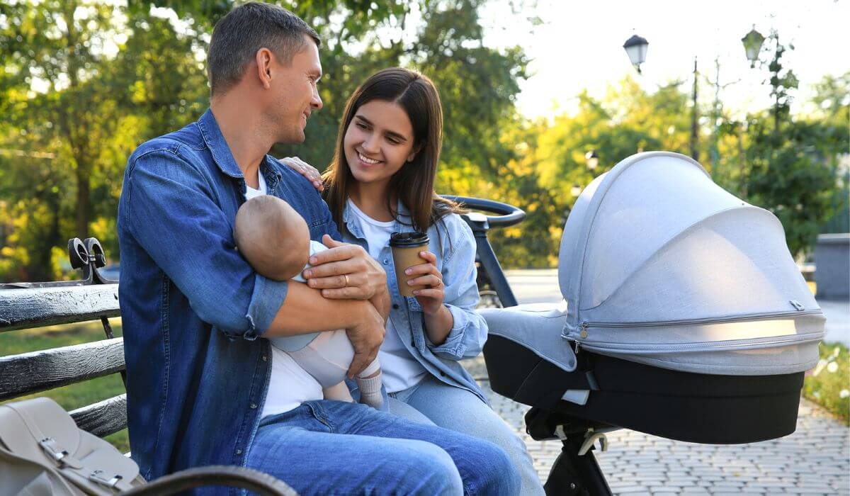 Husband and wife with newborn and stroller