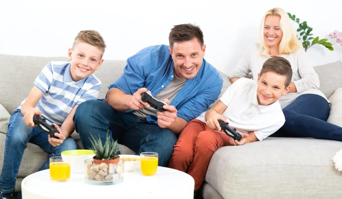Father and two sons playing video games