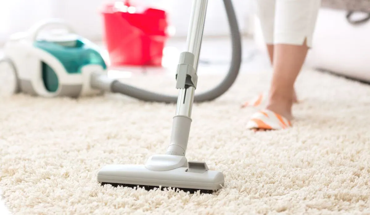 Woman vacuuming plus carpet