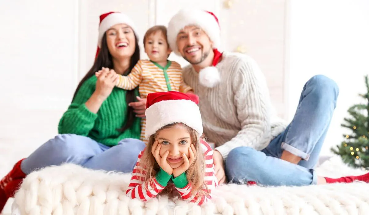 Family christmas photo on a bed