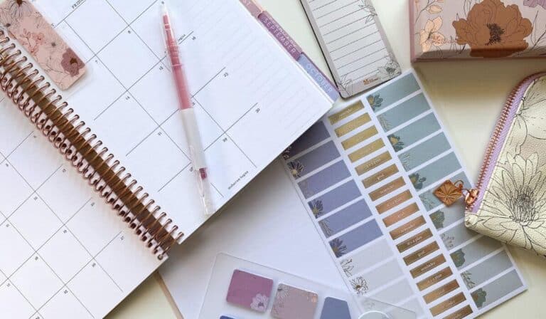 Erin condren planner open on desk with planning accessories