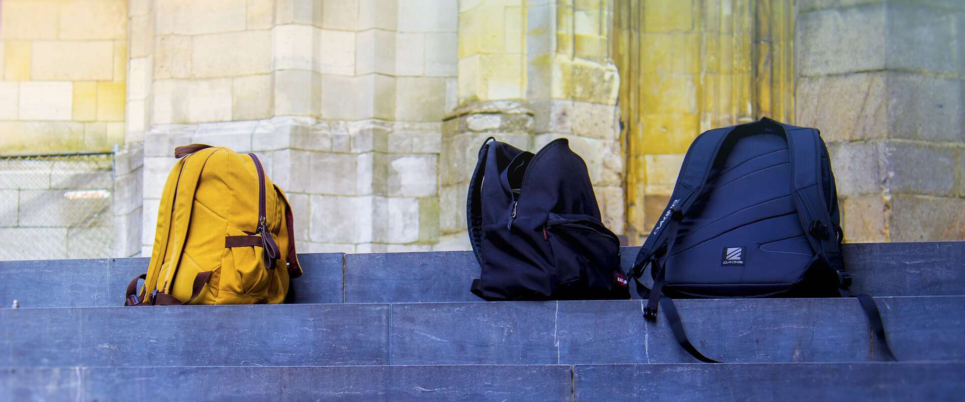 Simplify Your Before School Routine (And Never Be Late Again) 4 school backpacks on steps