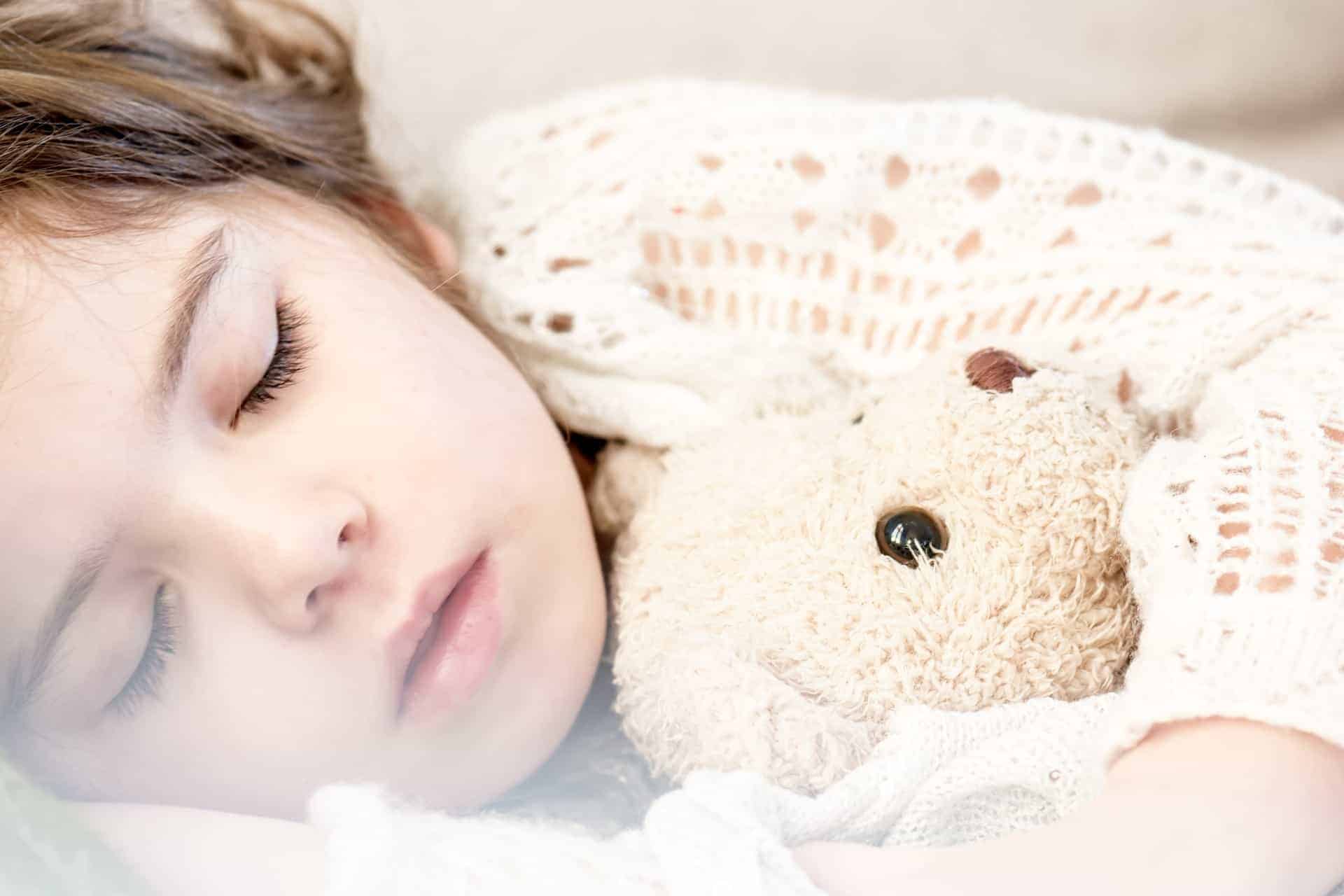 Child sleeping with teddy