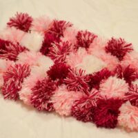pom pom rug in pink and white