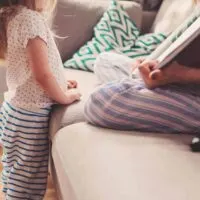 Pregnant mother reading to child about becoming big sister