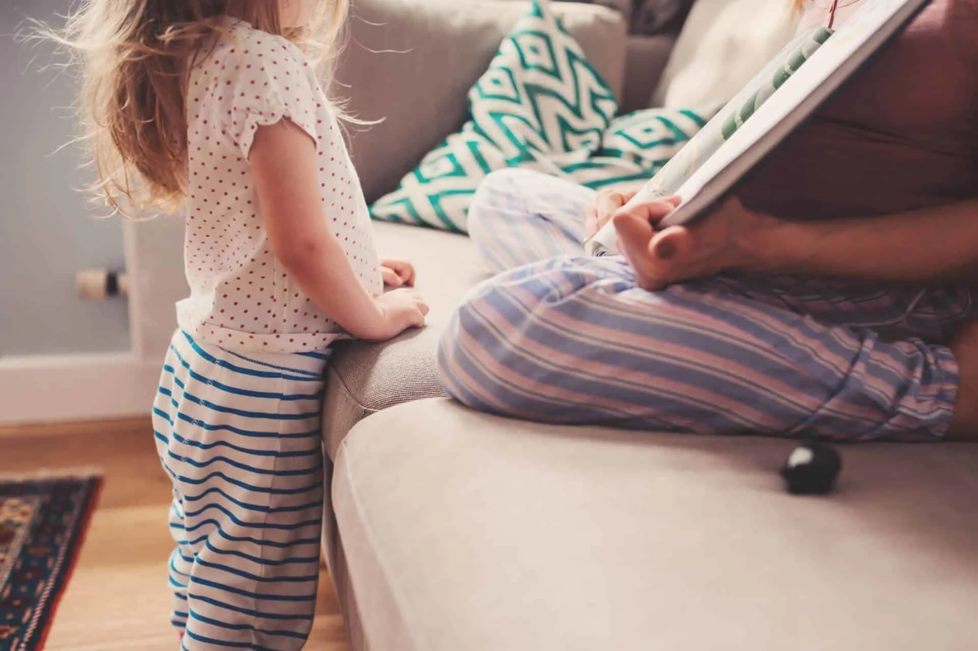 Pregnant mother reading to child about becoming big sister