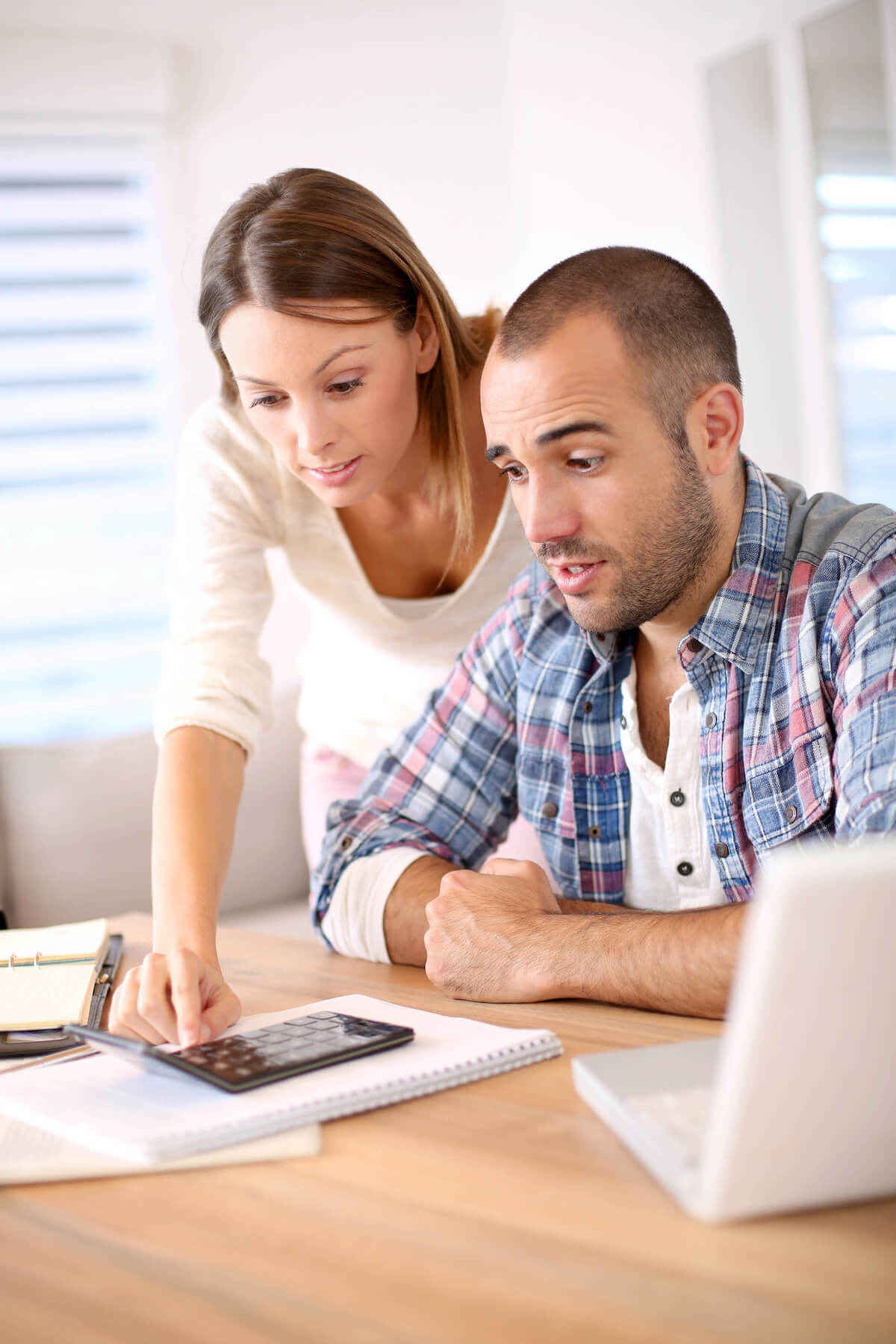 Couple working on budget at kitchen table