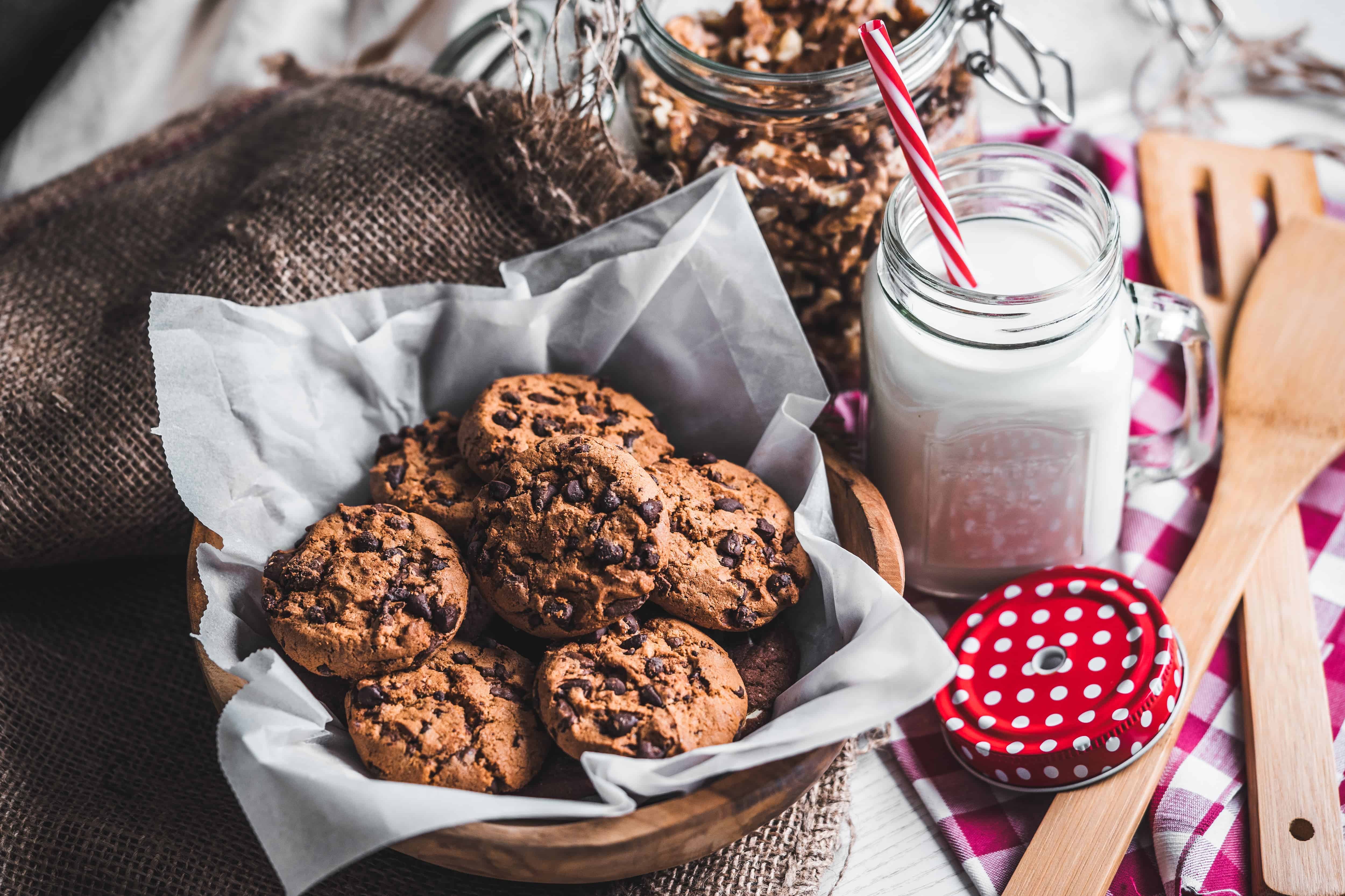 Baked cookies in basket with milk
