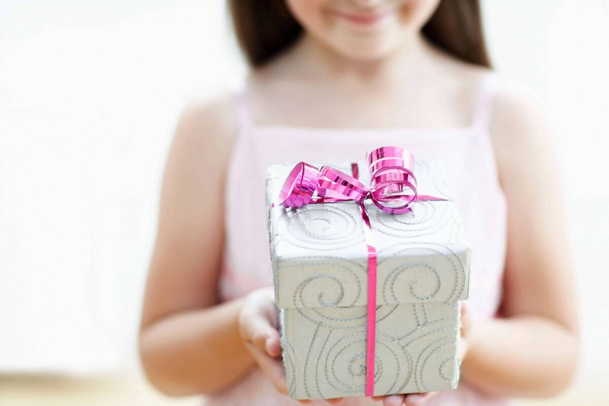 Non-toy gift ideas for kids girl holding gift box