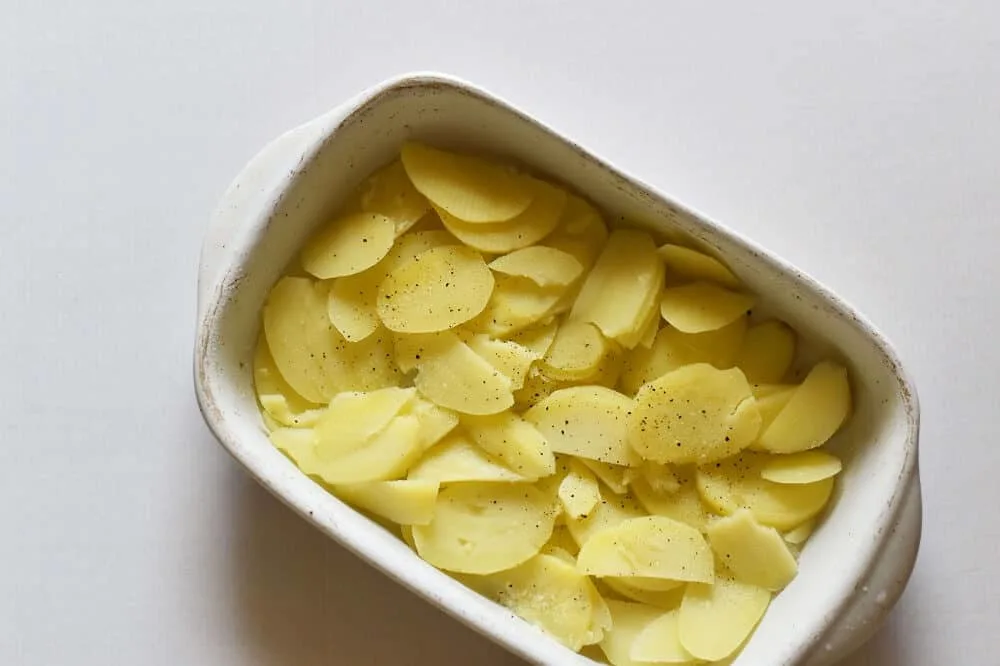 Layer potatoes in baking dish