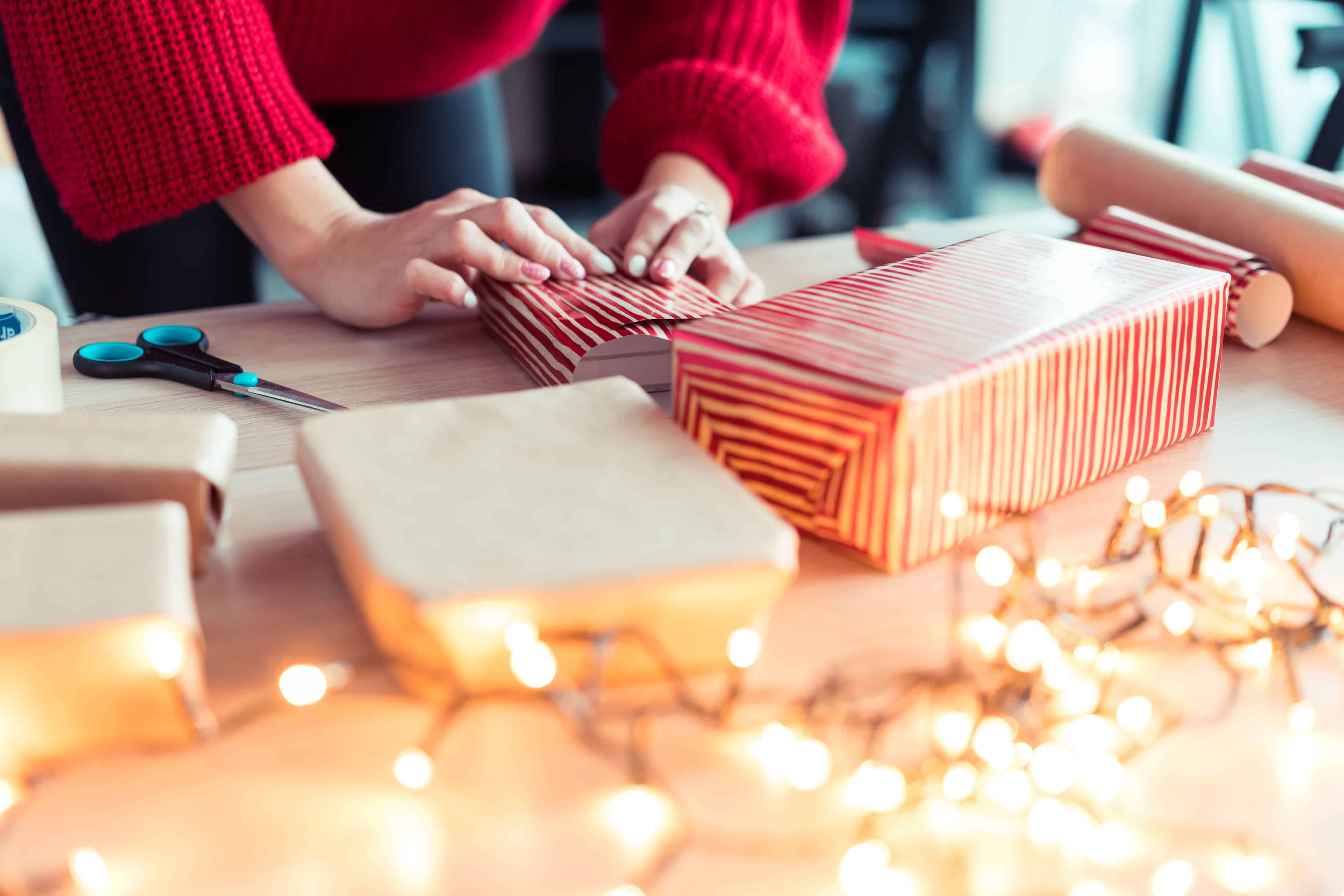 woman gift wrapping christmas presents
