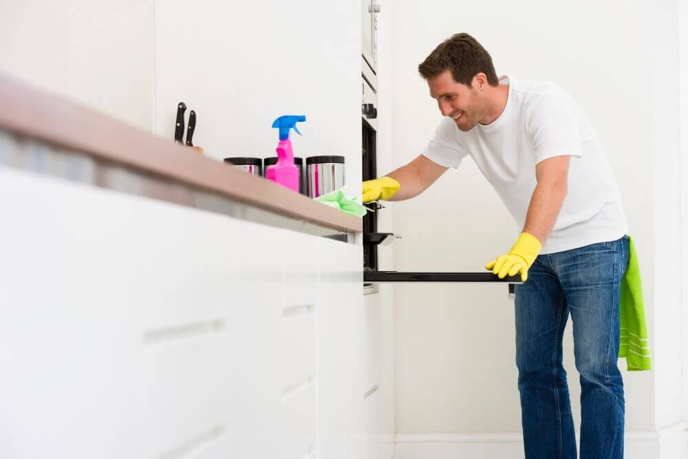 Man cleaning oven