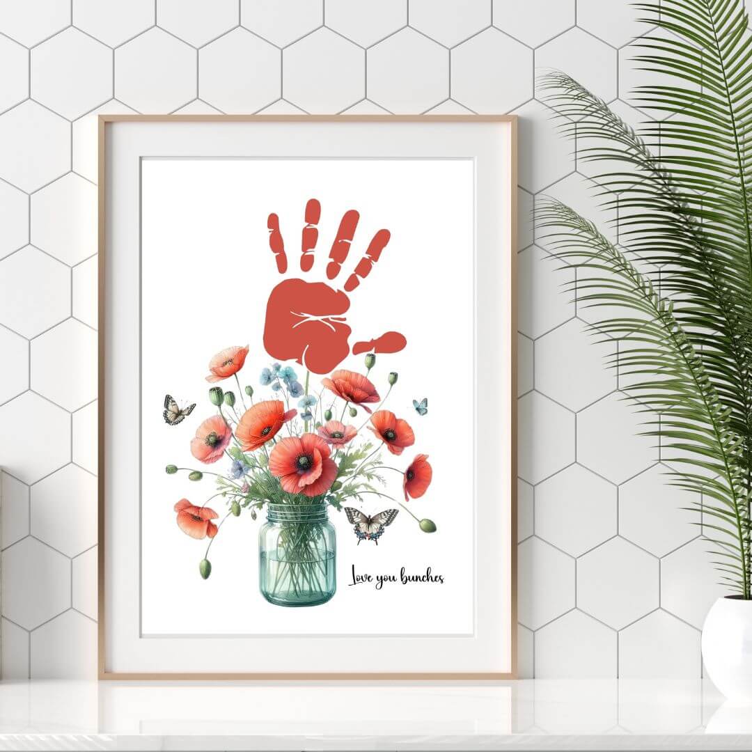 Mothers day handprint art flower bouquet in frame on kitchen counter.