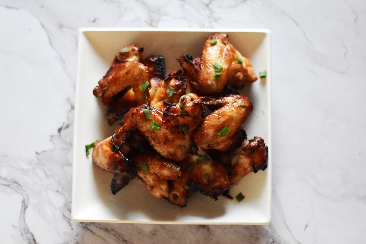 air fryer fish sauce chicken wings with spring onion garnish