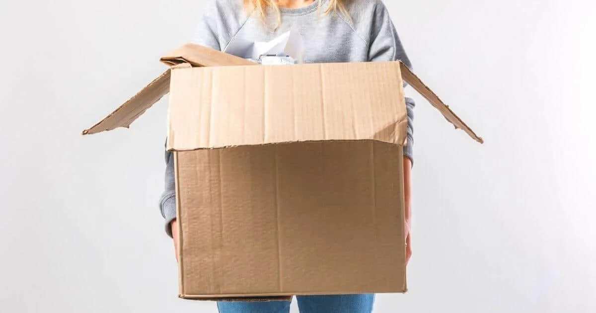 Lady with a cardboard box filled with unwanted clutter