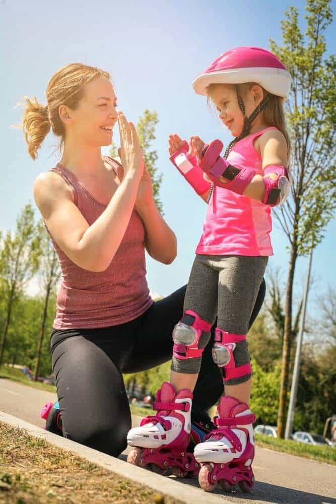 Mother and daughter rollerblading in the park