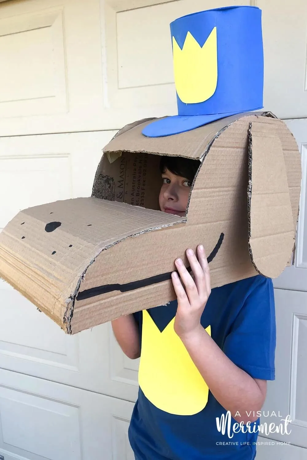 Homemade dog man costume made from cardboard boxes.
