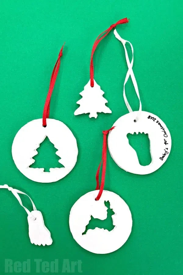 Handmade cookie cutter ornaments on a green background.
