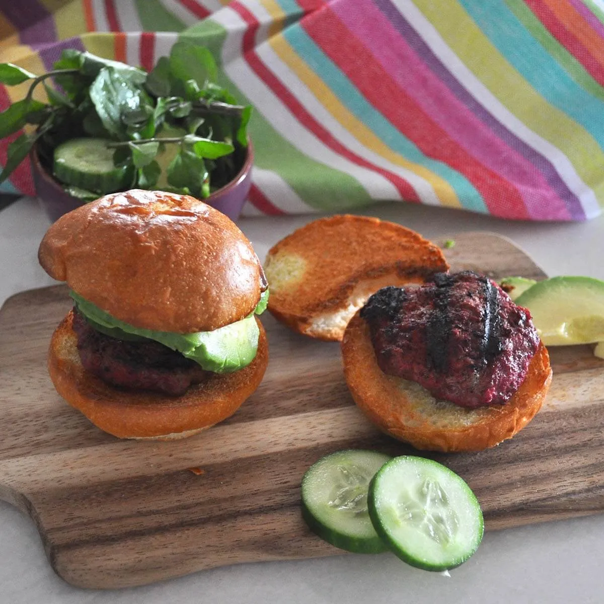 Beetroot beef burgers on a board