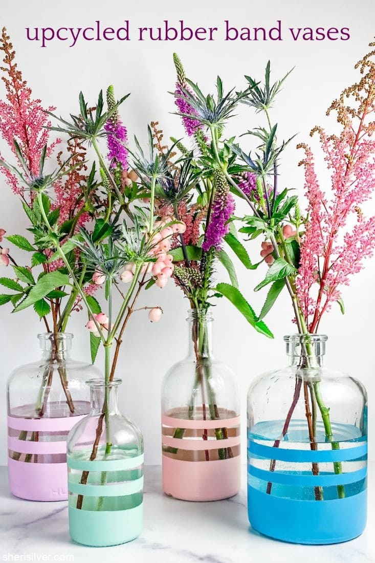 Rubber band vases in different colours with flower arrangements.