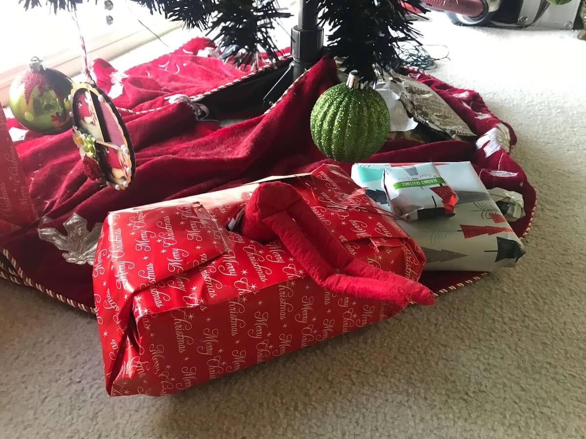 elf looking inside a gift.