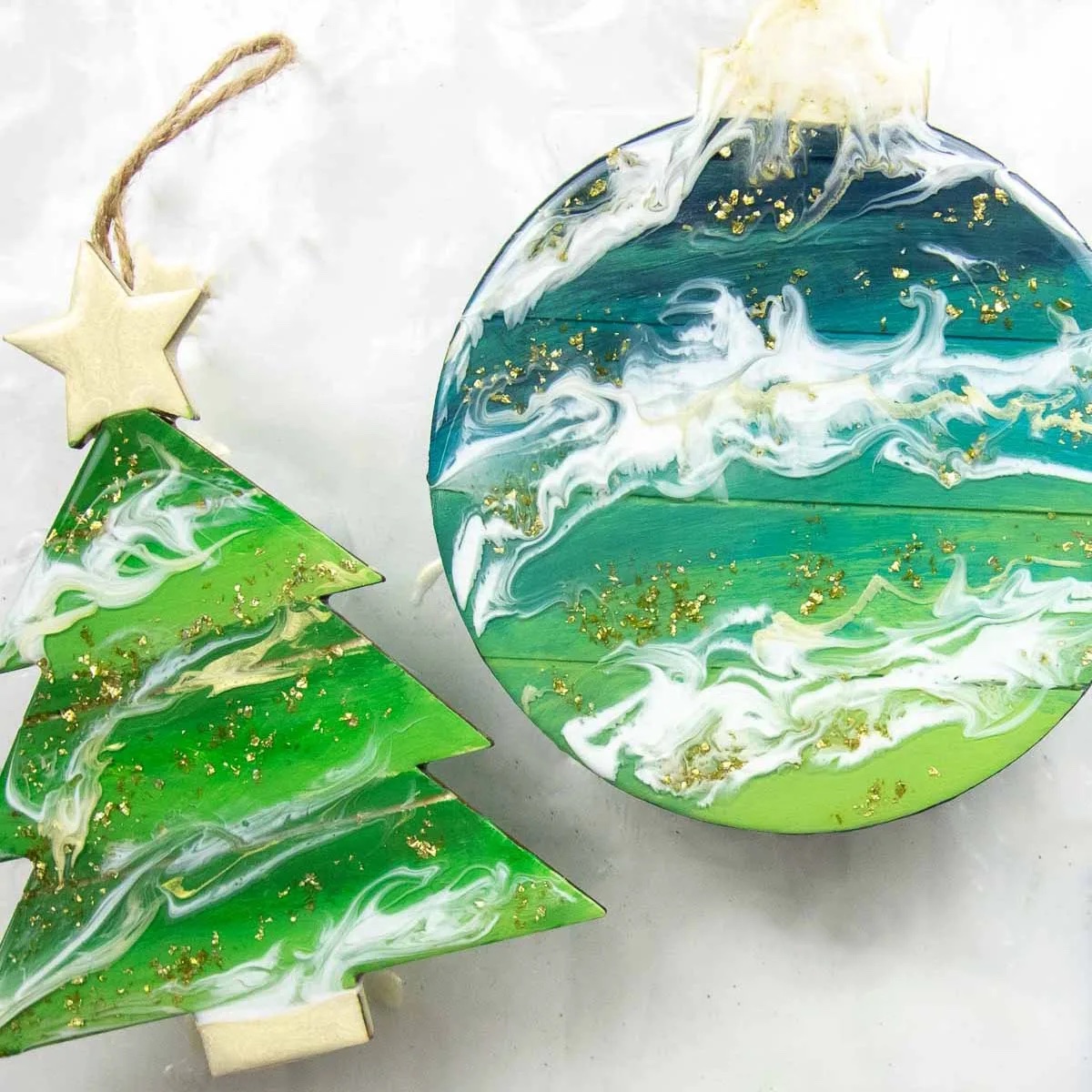 Resin christmas ornaments in round and christmas tree shapes.