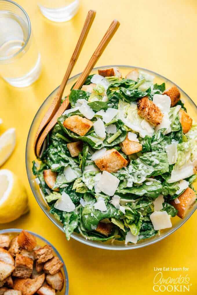 Caesar salad with serving spoons