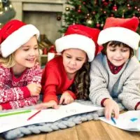 kids colouring under the christmas tree