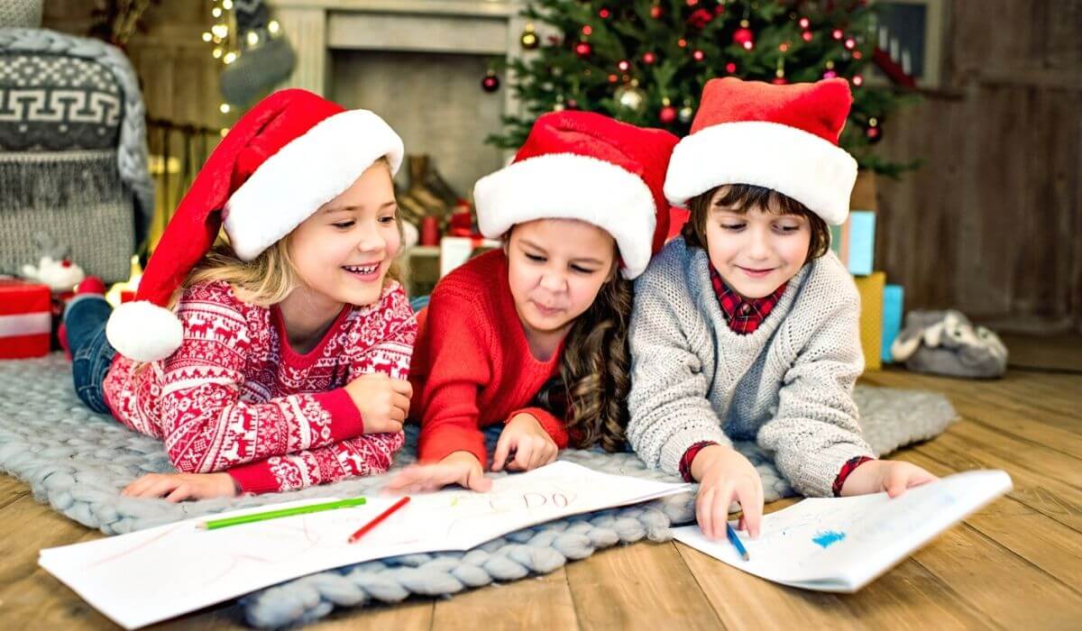 kids colouring under the christmas tree