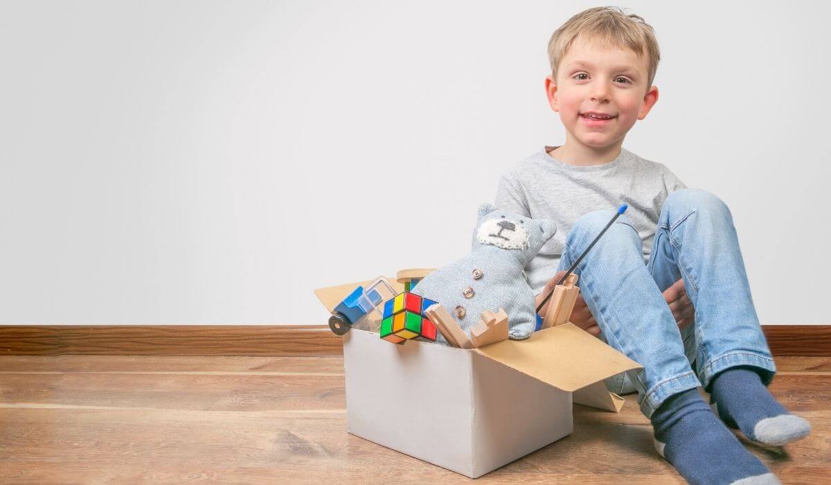 Boy with box of toys to donate