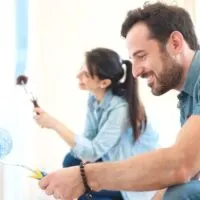 couple painting their wall blue