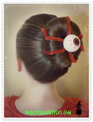 Silly eyeball hairstyle with a bun and pipe cleaners.