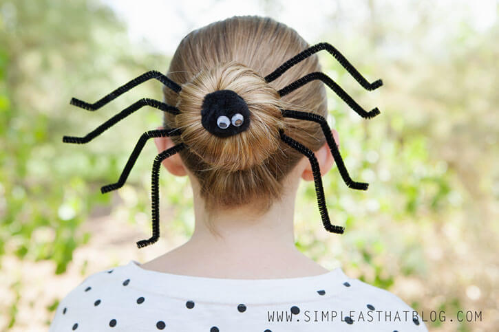 Spooky spider hairstyle with a bun and pipe cleaner legs.