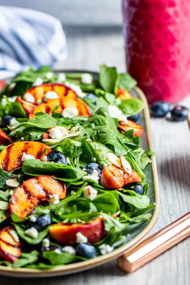 Grilled beach salad in serving dish on table