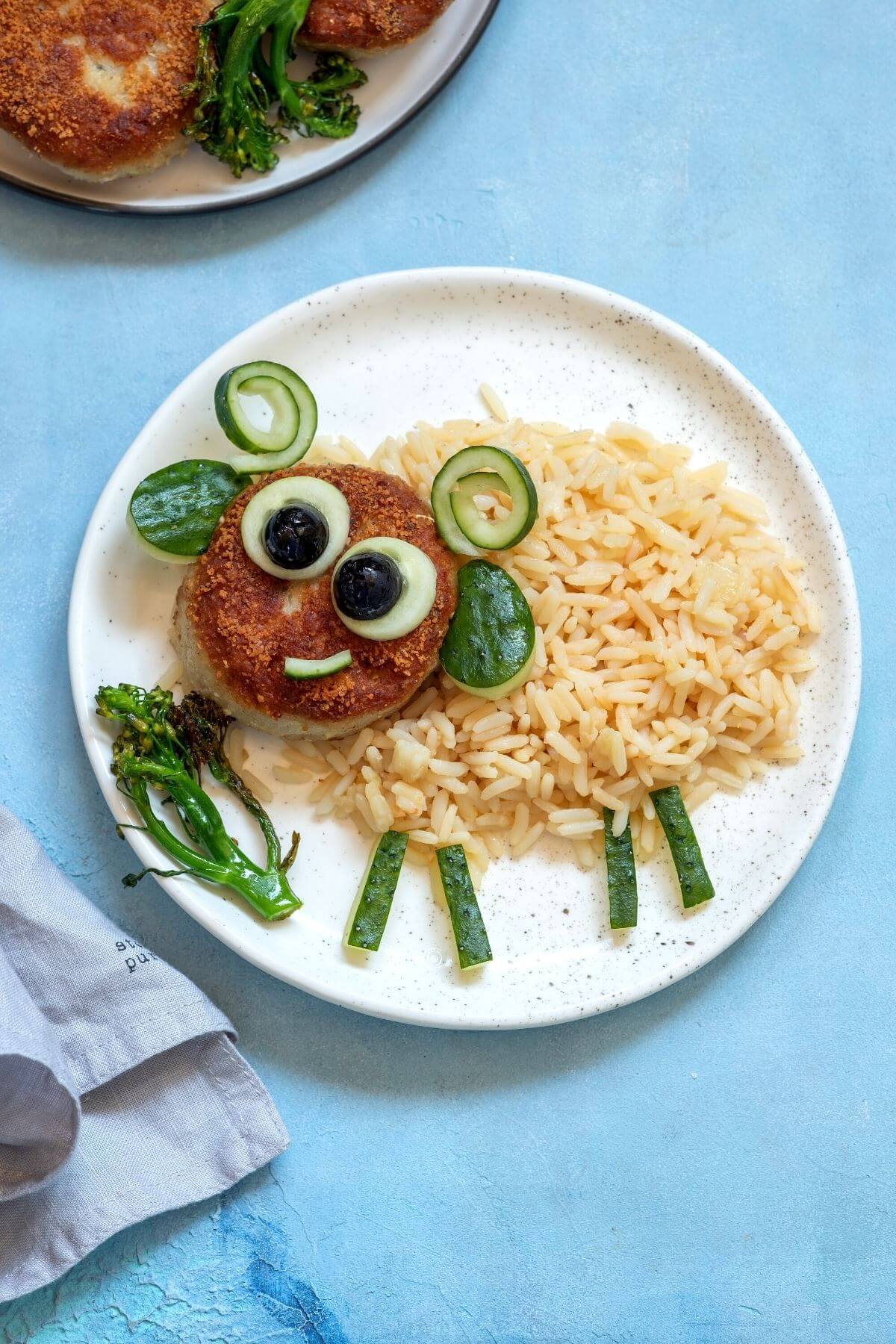 Rice and rissole on a plate shaped like a sheep
