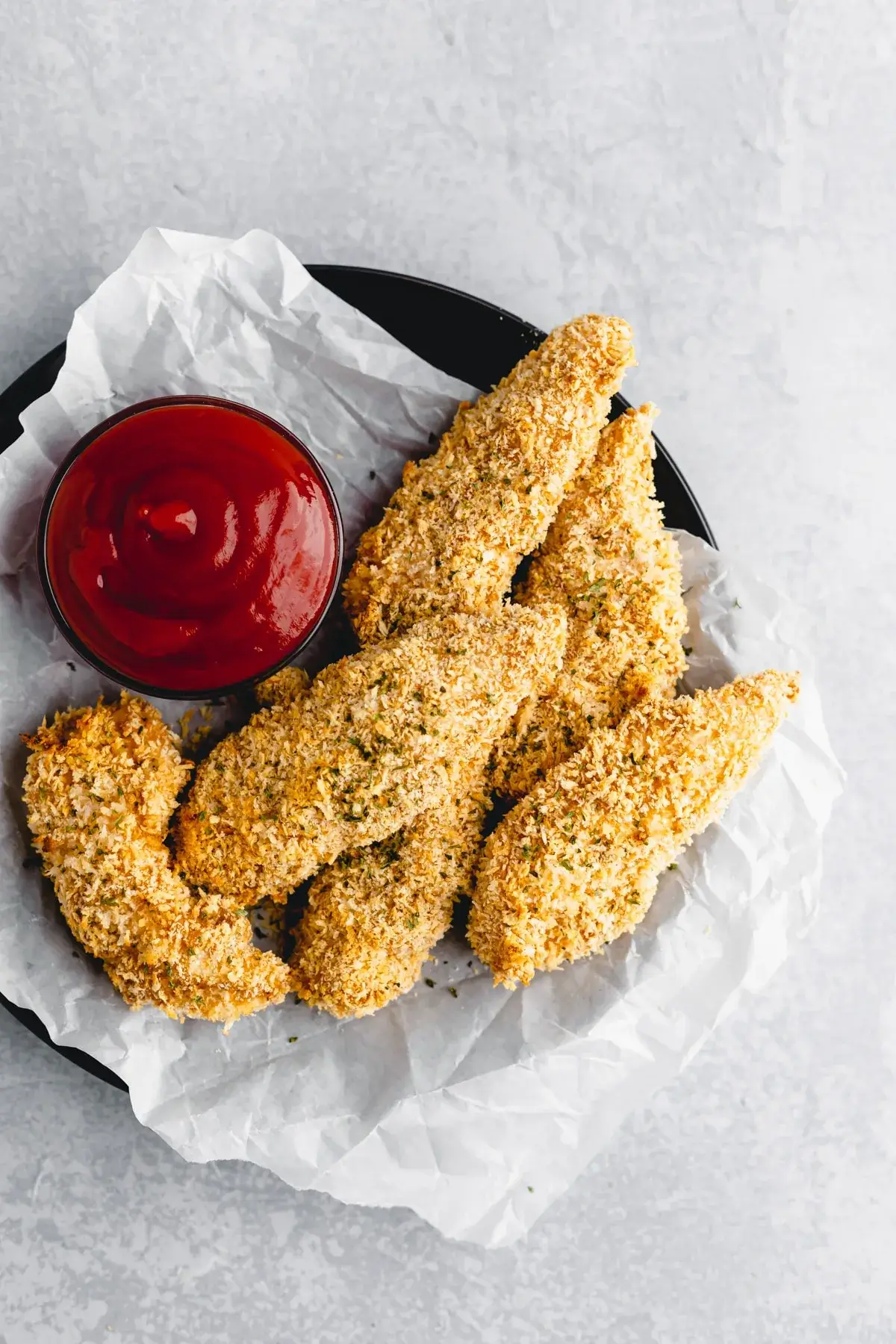 Baked chicken tenders on a plate with sauce