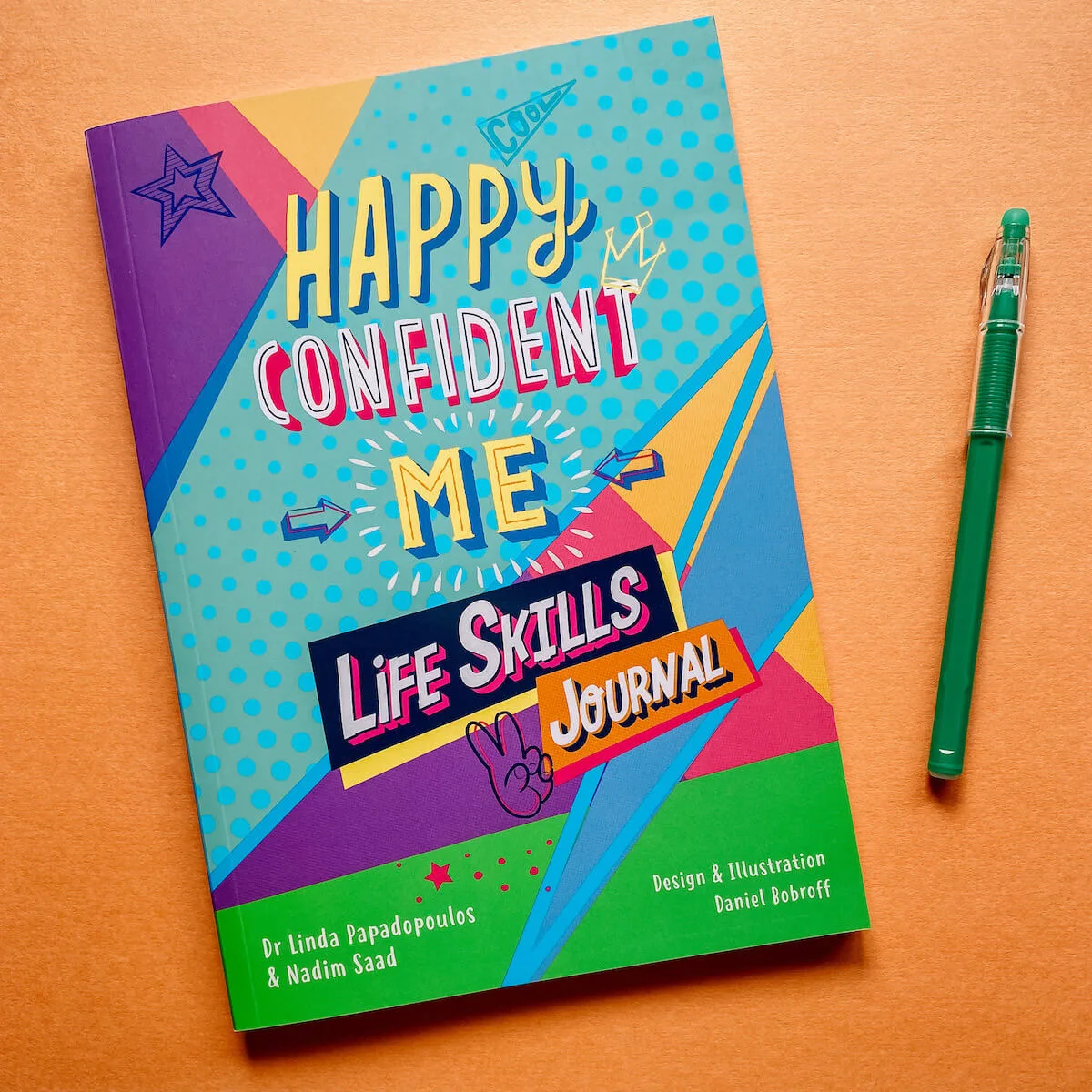 Happy confident me life skills journal on desk with pen