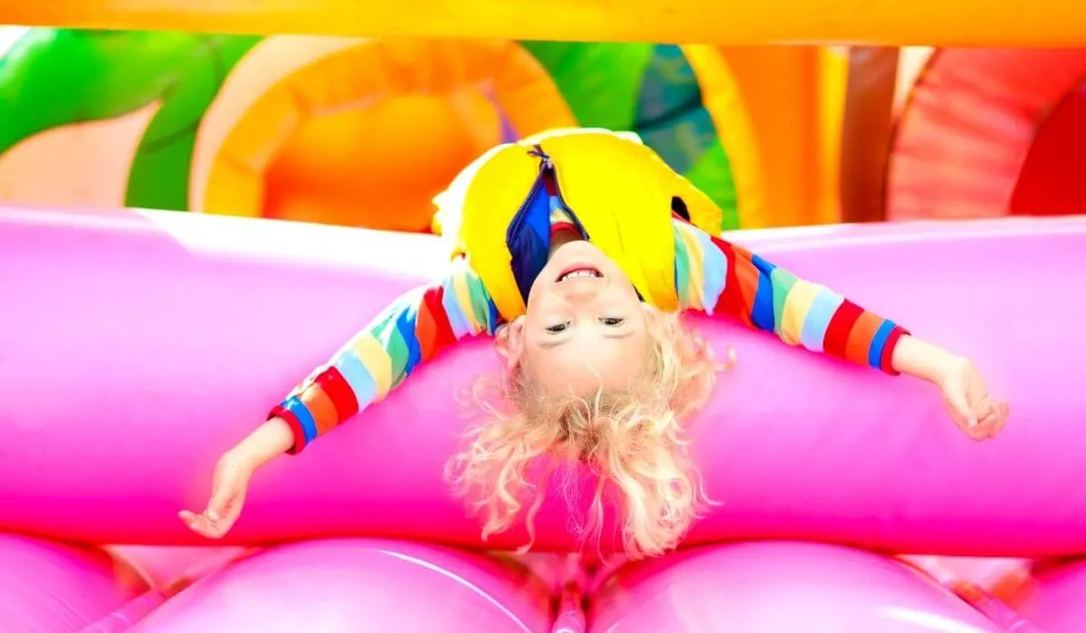 Child upside down on a jumping castle