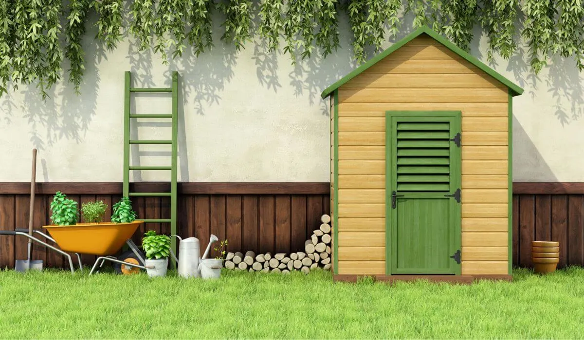 Garden shed with green door and ladder against house