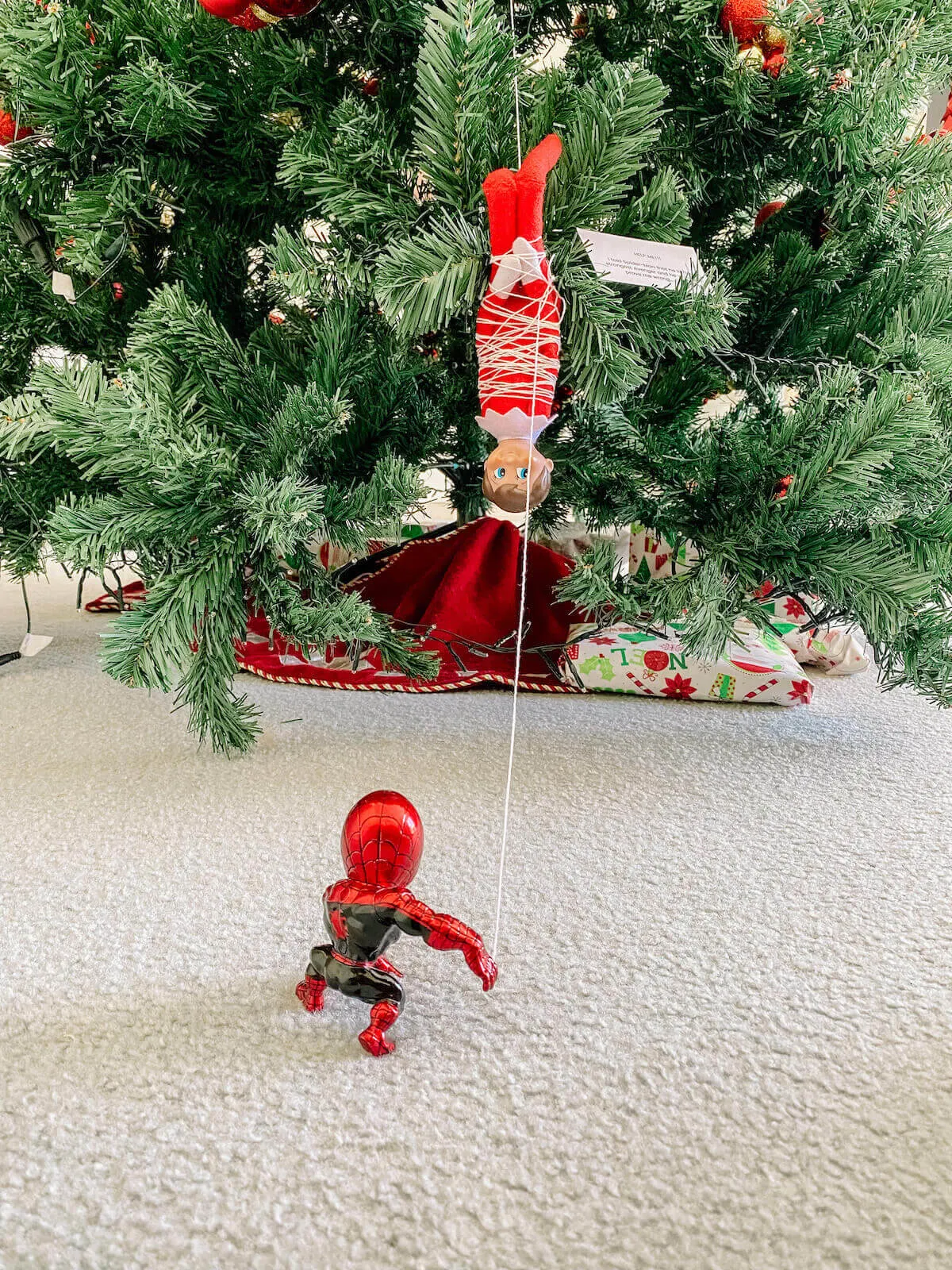 Spider-man with elf on the shelf in web
