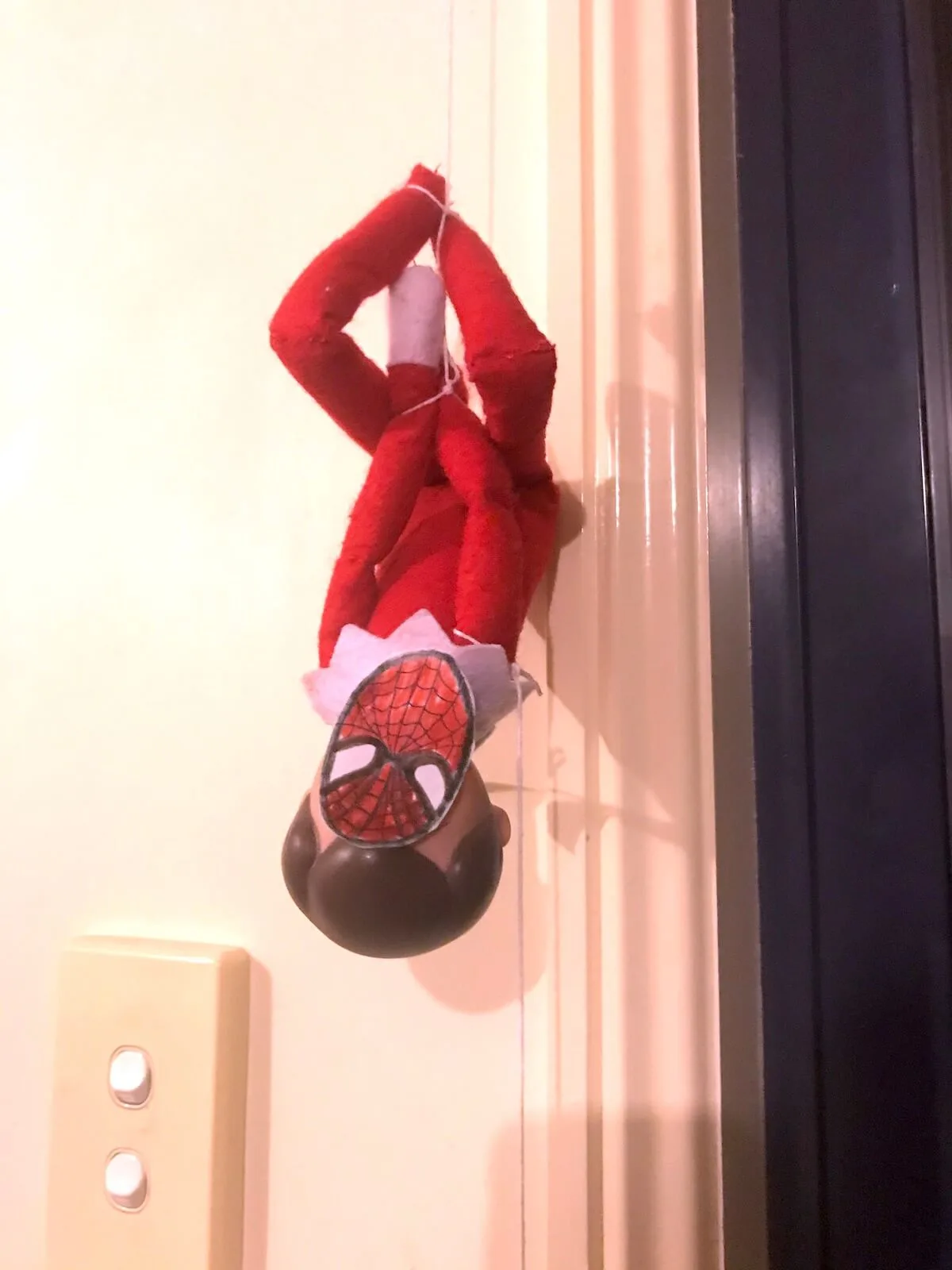 Elf on the shelf spiderman hanging upside down
