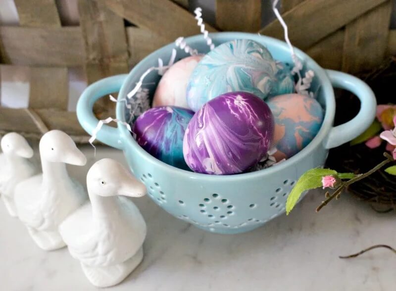 Paint poured easter eggs in colander