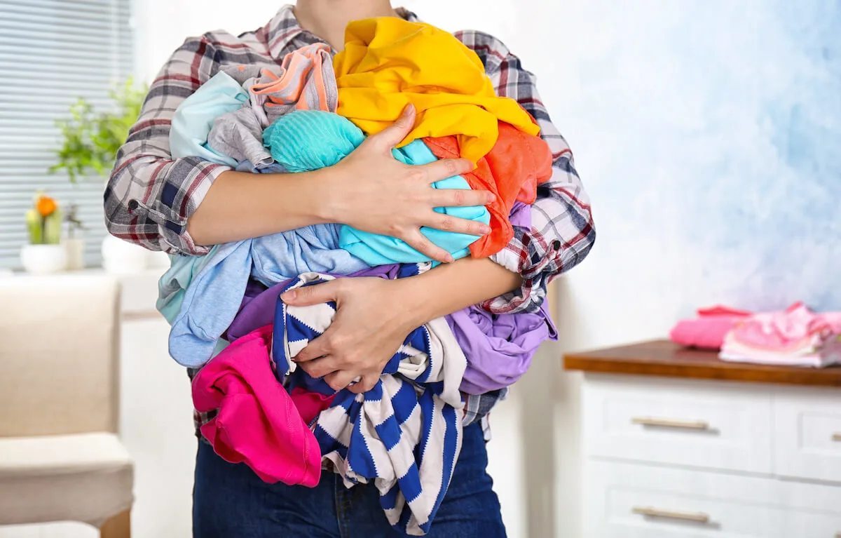 Woman with armful of dirty laundry