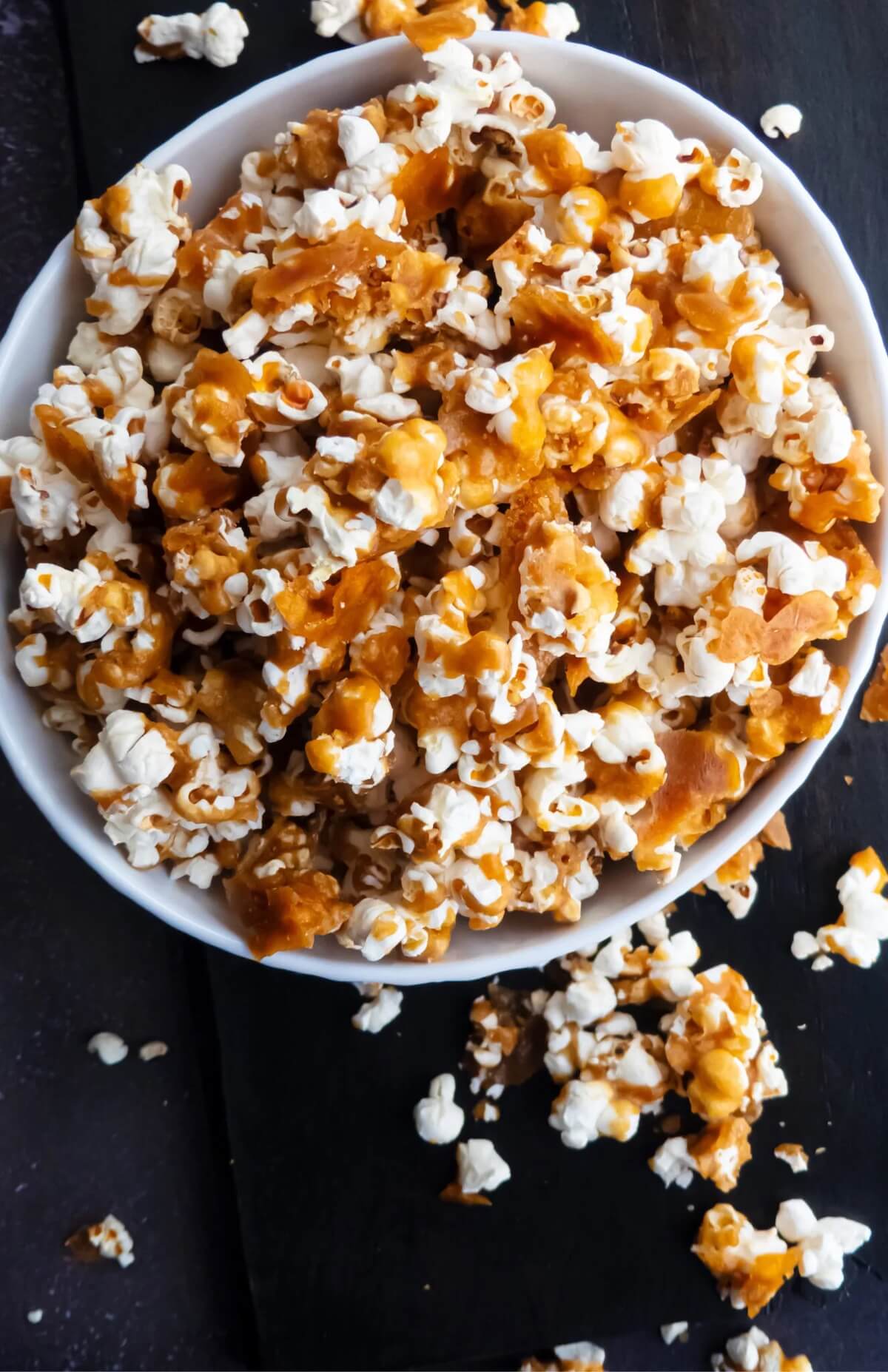 Caramel popcorn overflowing from a bowl